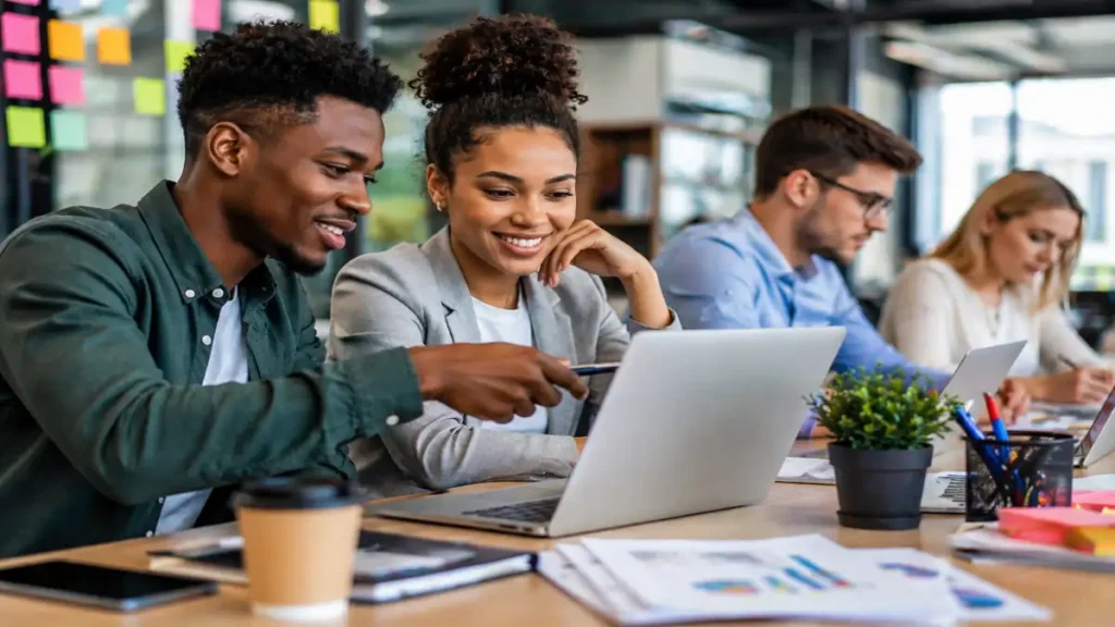 Young South African graduates collaborating in a modern office during a Business Analysis Learnership programme in Johannesburg and Cape Town.