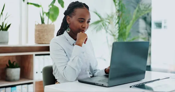 laernsetahub author Young professional woman working on a laptop in a modern office workspace